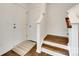 Welcoming entryway featuring hardwood stairs, a coat closet, and a neutral color scheme, exuding modern comfort at 3855 Tersk Dr, Midland, NC 28107