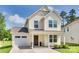 Lovely two-story home with a covered front porch, attached garage, and landscaped garden, perfect for families at 3855 Tersk Dr, Midland, NC 28107