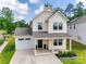 Inviting two-story home featuring a covered porch, attached garage, and neatly landscaped front yard at 3855 Tersk Dr, Midland, NC 28107