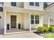Inviting front porch showcasing the home's entrance, pillars, decorative plants, and manicured landscaping at 3855 Tersk Dr, Midland, NC 28107