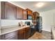 Kitchen with stainless steel appliances, dark wood cabinets, and wood-look floors at 3855 Tersk Dr, Midland, NC 28107