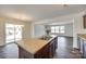 Kitchen island with a sink and dark wood cabinets in an open kitchen space at 3855 Tersk Dr, Midland, NC 28107
