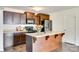 Kitchen island with a sink and dark wood cabinets at 3855 Tersk Dr, Midland, NC 28107