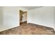 Open living room with wood-look floors, a staircase, and ample space for furniture arrangement at 3855 Tersk Dr, Midland, NC 28107