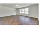 Living area featuring three windows and wood-look flooring at 3855 Tersk Dr, Midland, NC 28107