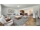 Bright, open living space with modern furnishings, wood floors, and seamless flow to the kitchen and dining areas at 3855 Tersk Dr, Midland, NC 28107