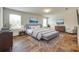 Comfortable main bedroom featuring wood floors, area rug and tray ceiling at 3855 Tersk Dr, Midland, NC 28107