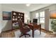 Bright office space featuring wood floors, built-in bookcase, and a large window for natural light at 3855 Tersk Dr, Midland, NC 28107