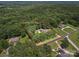 An aerial view shows the property, surrounded by mature trees, featuring a pool and highlighted property lines at 394 E Goldmine Rd, Wadesboro, NC 28170
