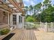 Charming back patio with wooden pergola, swing, and potted plants at 394 E Goldmine Rd, Wadesboro, NC 28170