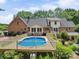 Beautiful backyard featuring an in-ground pool, deck, and lush landscaping at 394 E Goldmine Rd, Wadesboro, NC 28170