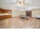 Spacious basement with an area for activities featuring vinyl flooring, a brick fireplace, and lots of ceiling fans at 394 E Goldmine Rd, Wadesboro, NC 28170