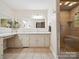 Bright bathroom featuring a walk-in shower, double vanity and ceramic tile flooring at 394 E Goldmine Rd, Wadesboro, NC 28170
