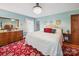 This cozy bedroom features a red rug, blue walls, and a decorative chandelier for ambient lighting at 394 E Goldmine Rd, Wadesboro, NC 28170