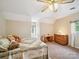 Light and airy bedroom with neutral walls, ceiling fan, and plenty of natural light from the two windows at 394 E Goldmine Rd, Wadesboro, NC 28170