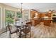 Bright breakfast nook with wood floors, updated cabinets, granite counters, and outdoor views at 394 E Goldmine Rd, Wadesboro, NC 28170