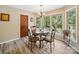 Cozy dining area with natural light, a round table, and hardwood floors at 394 E Goldmine Rd, Wadesboro, NC 28170