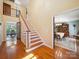 Inviting entryway with hardwood floors, staircase, and view into the dining room at 394 E Goldmine Rd, Wadesboro, NC 28170