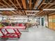 Spacious garage with an open ceiling and ample workspace featuring multiple tables and tool storage at 394 E Goldmine Rd, Wadesboro, NC 28170