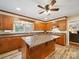 Spacious kitchen featuring wooden cabinets, granite countertops, a kitchen island, and modern appliances at 394 E Goldmine Rd, Wadesboro, NC 28170