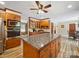 Well-equipped kitchen with wooden cabinets, granite countertops, large island, and modern appliances at 394 E Goldmine Rd, Wadesboro, NC 28170