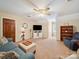 Spacious living room featuring plush blue seating, ceiling fan, and built in bookcase and entertainment center at 394 E Goldmine Rd, Wadesboro, NC 28170