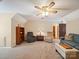 Comfortable living room featuring lots of plush seating, ceiling fan, and built in bookcase for storage at 394 E Goldmine Rd, Wadesboro, NC 28170