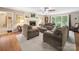 Comfortable living room featuring a stone fireplace, ceiling fan and neutral colored furnishings at 394 E Goldmine Rd, Wadesboro, NC 28170