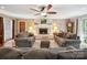 Comfortable living room featuring a stone fireplace, ceiling fan and neutral colored furnishings at 394 E Goldmine Rd, Wadesboro, NC 28170