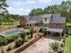 Expansive home exterior showcasing a pool, well-kept landscaping, a covered garage, and an elevated deck at 394 E Goldmine Rd, Wadesboro, NC 28170