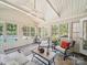 Relaxing sunroom with vaulted ceilings, ceiling fan, lots of windows and brick flooring at 394 E Goldmine Rd, Wadesboro, NC 28170