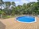 Inviting private pool featuring a wooden deck and a safety fence at 394 E Goldmine Rd, Wadesboro, NC 28170