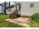Concrete back patio with stairs leading to a door, plus healthy landscaping at 4519 Rock Stream Dr, Charlotte, NC 28269