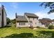 A spacious backyard with a view of the house, showcasing the siding and brick foundation at 4519 Rock Stream Dr, Charlotte, NC 28269