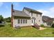 The backyard features a well-maintained lawn and a raised patio with steps leading to a side door at 4519 Rock Stream Dr, Charlotte, NC 28269