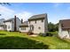 Expansive backyard with lush green grass and partial views of neighboring houses and mature trees at 4519 Rock Stream Dr, Charlotte, NC 28269