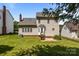 The backyard features a well-maintained lawn and a raised patio with steps leading to a side door at 4519 Rock Stream Dr, Charlotte, NC 28269