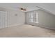Attic bedroom featuring neutral walls, carpet, and two windows at 4519 Rock Stream Dr, Charlotte, NC 28269