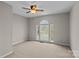 Bedroom featuring neutral walls, carpet, and a unique arched window at 4519 Rock Stream Dr, Charlotte, NC 28269