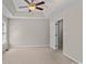 Carpeted bedroom with tray ceiling and natural light at 4519 Rock Stream Dr, Charlotte, NC 28269
