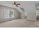 Attic bedroom featuring neutral walls, carpet, and multiple windows at 4519 Rock Stream Dr, Charlotte, NC 28269
