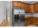 Kitchen featuring stainless steel refrigerator, wooden cabinets, and granite countertops, offering a functional design at 4519 Rock Stream Dr, Charlotte, NC 28269