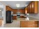 Spacious kitchen with stainless steel appliances, granite countertops, a breakfast bar, and tiled floor and backsplash at 4519 Rock Stream Dr, Charlotte, NC 28269