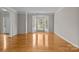 Bright living room features beautiful hardwood floors, a bay window, and neutral paint, creating an inviting atmosphere at 4519 Rock Stream Dr, Charlotte, NC 28269