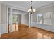 Open-concept living area with hardwood floors, decorative pillars, and large windows offers abundant natural light at 4519 Rock Stream Dr, Charlotte, NC 28269