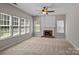 Living room featuring a brick fireplace, large windows, and neutral carpeting at 4519 Rock Stream Dr, Charlotte, NC 28269