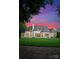 The house has a large grassy yard and patio with an outdoor fireplace and grill at 4714 Ockley Manor Ln, Charlotte, NC 28226