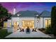 The backyard offers a stone patio with a grill, outdoor seating and an exterior view of the home at 4714 Ockley Manor Ln, Charlotte, NC 28226