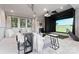 Finished basement with a golf simulator, projector screen, comfortable seating, and stylish decor at 4714 Ockley Manor Ln, Charlotte, NC 28226