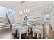 Elegant dining area with a glass table, modern lighting, and views into the gourmet kitchen at 4714 Ockley Manor Ln, Charlotte, NC 28226